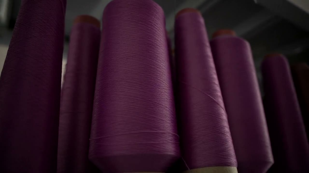 Performance yarns on cones in the JINDOYO knitting hall